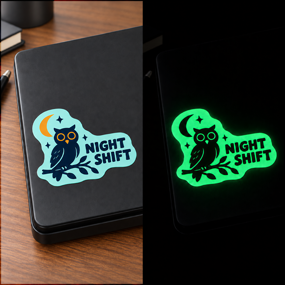 Custom glow in the dark sticker on a laptop — full color by day, glowing green at night